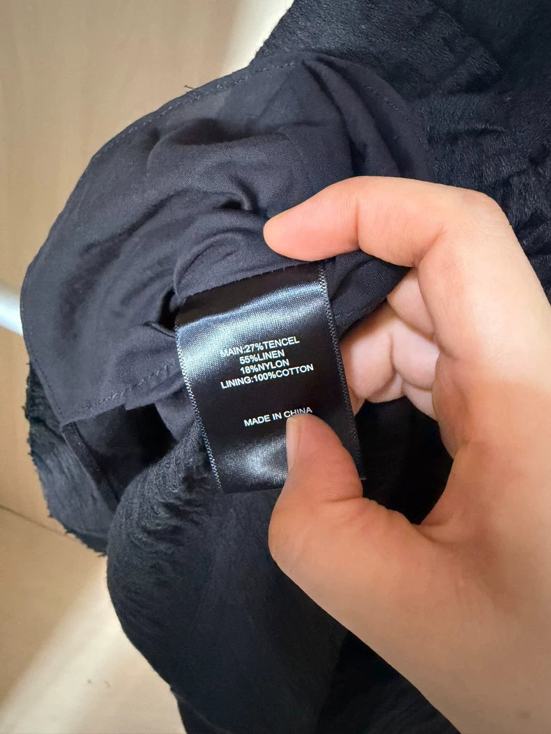 Black tiered mini dress — fibre label detail