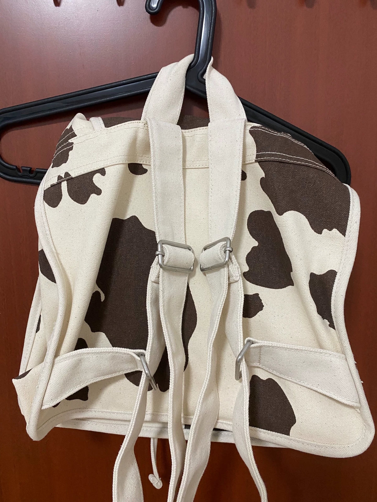 Actual BAGGU cow-print backpack straps and back