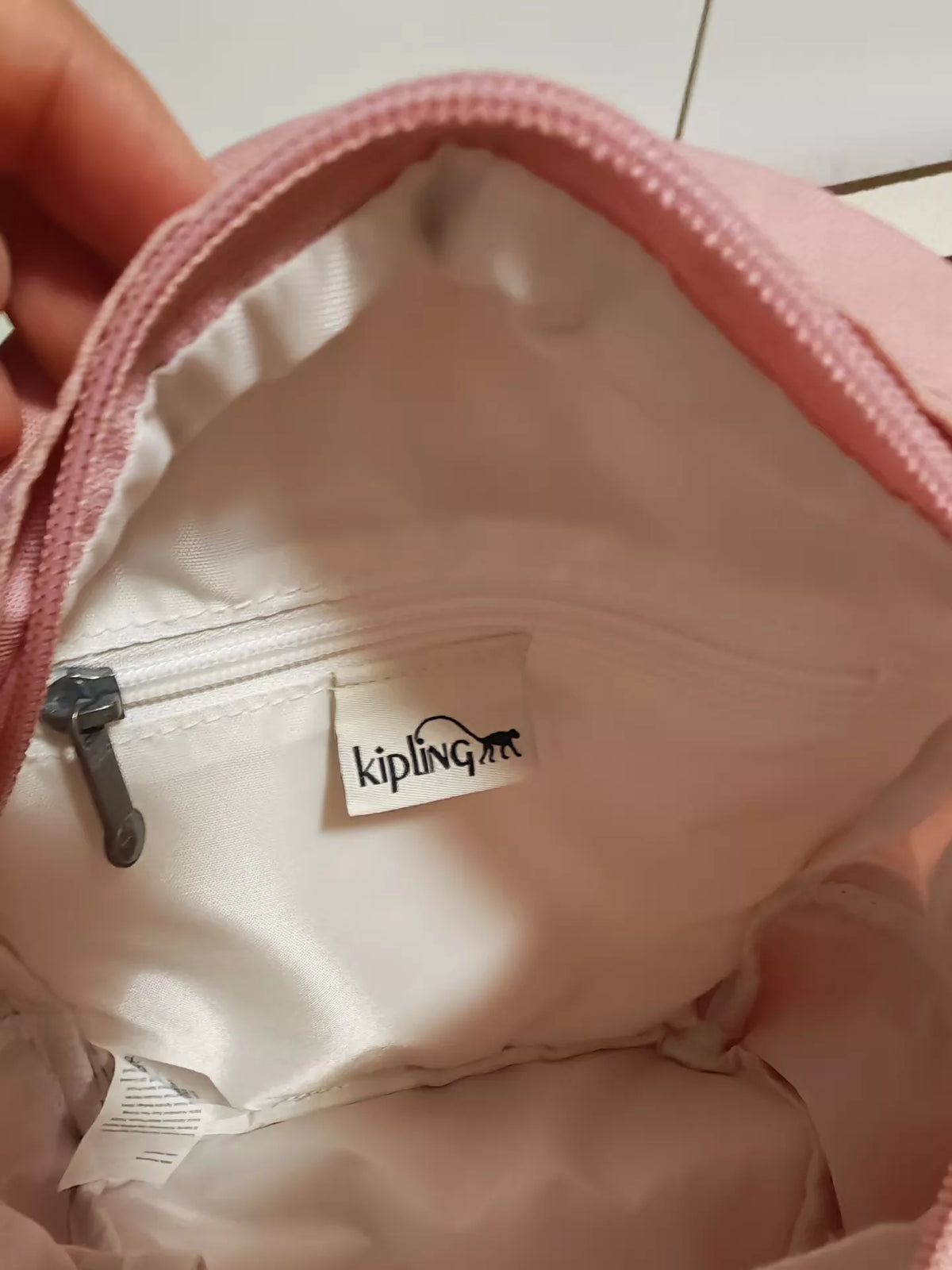 Kipling pink mini backpack lining and brand label