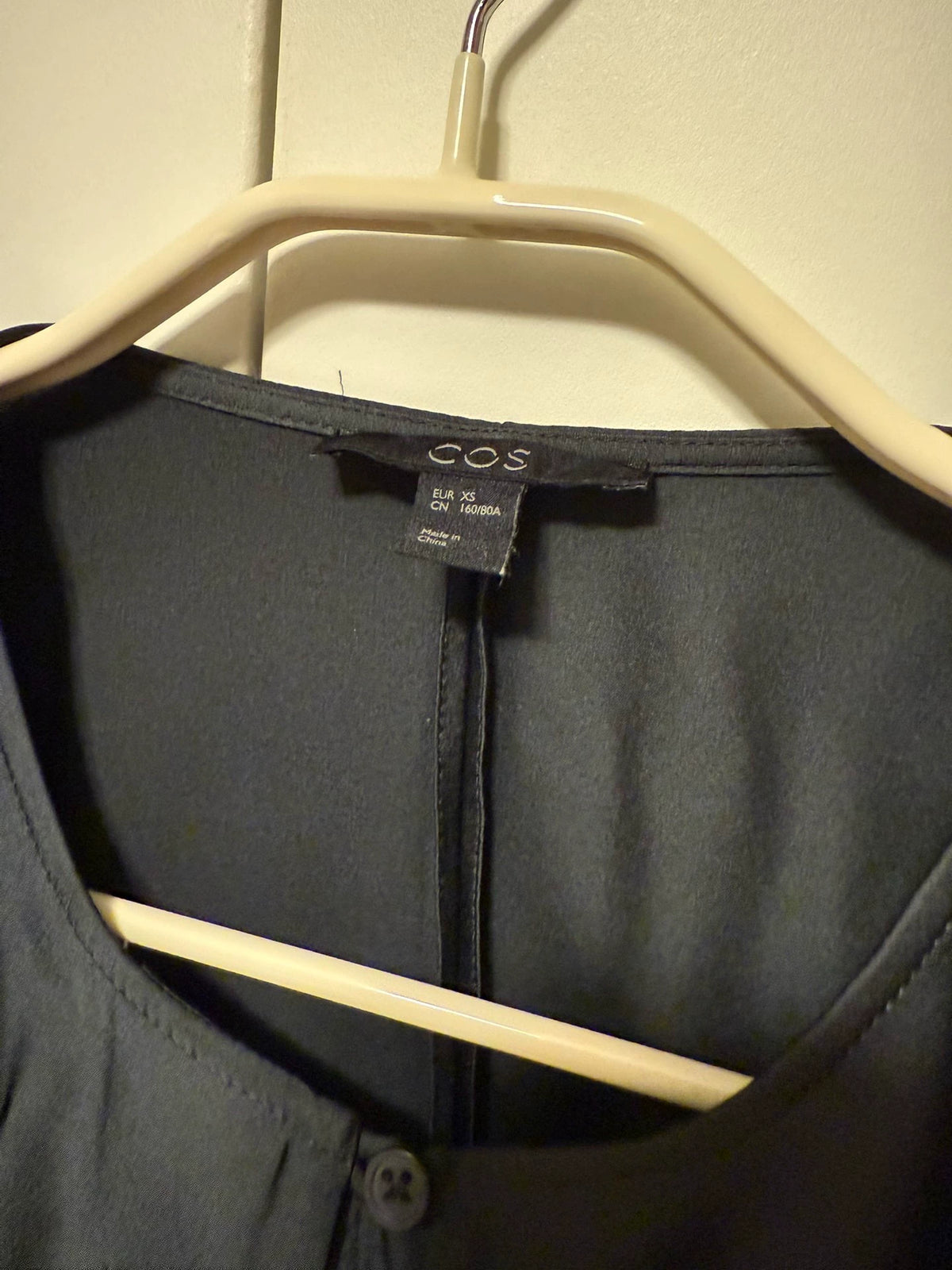 COS XS label on dark green blouse