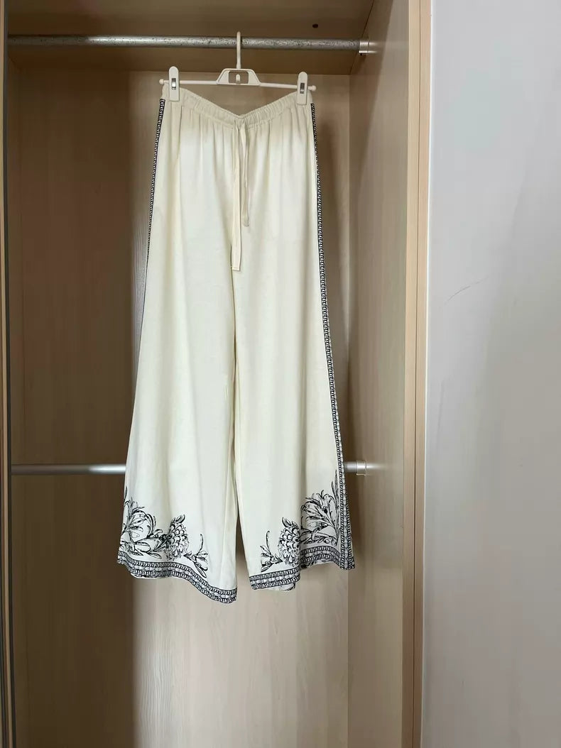 Ivory floral-border linen-blend wide-leg trousers — clean full view