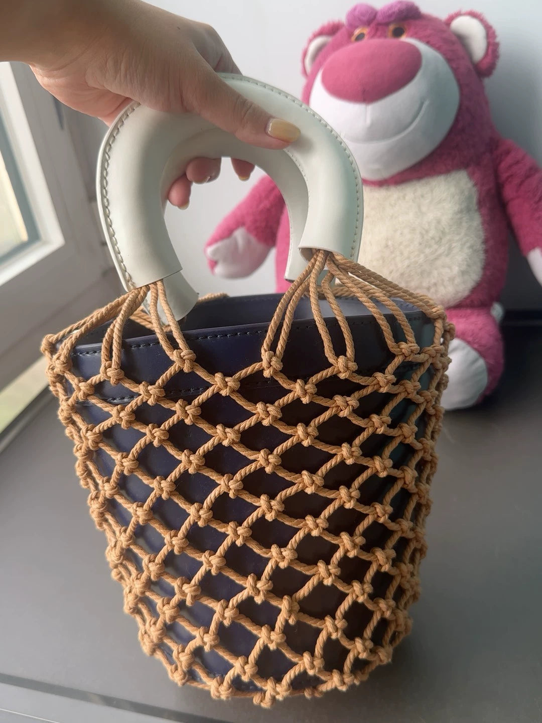STAUD Woven Leather Handbag — front view