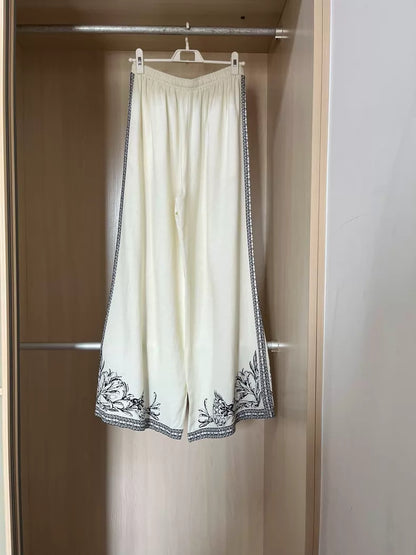 Floral-border trousers — fabric detail