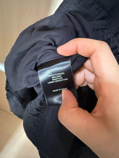Black tiered mini dress — fibre label detail