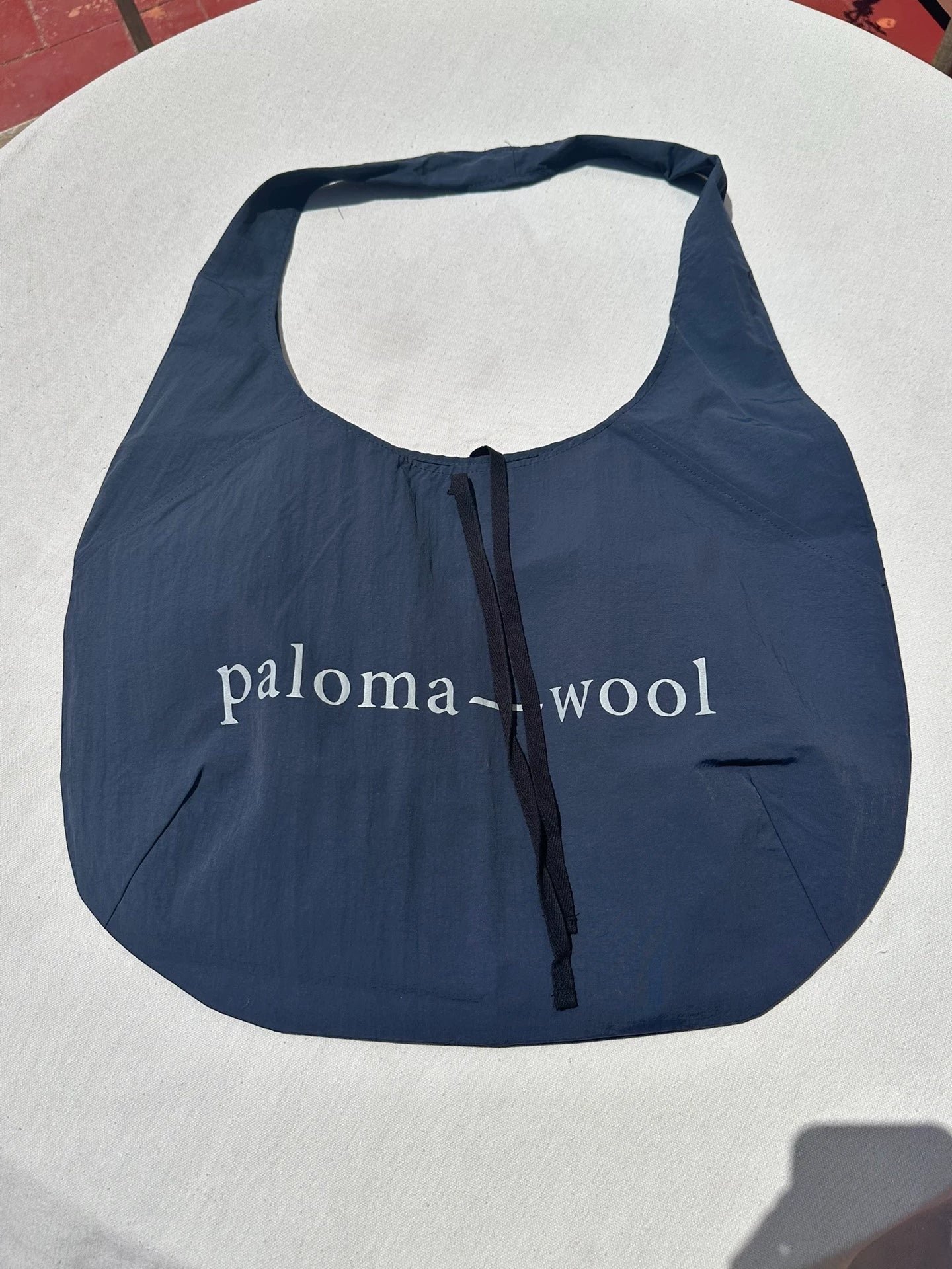 Paloma Wool Navy Soft Bag — front view