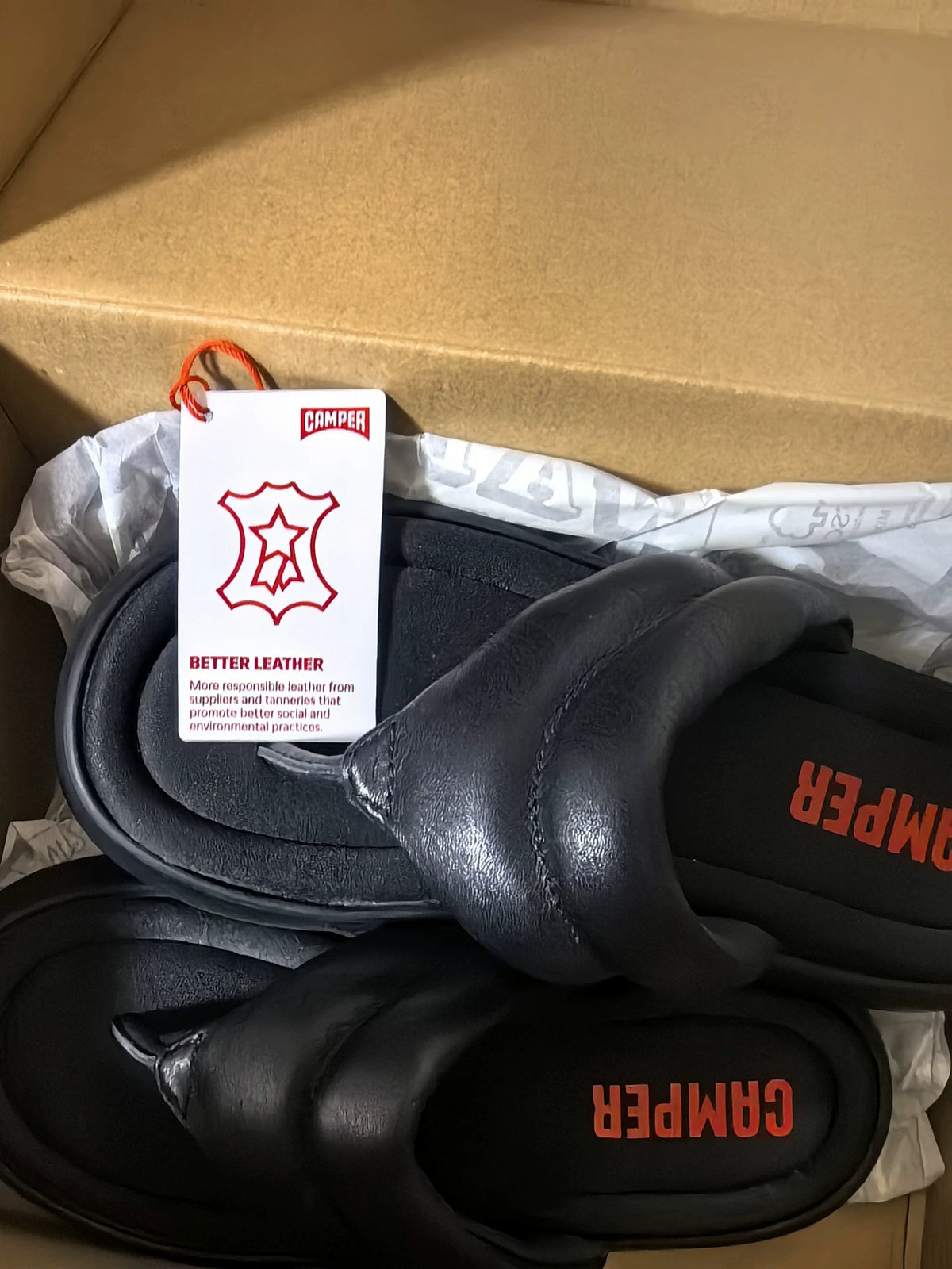 Camper sandals with attached leather tag and packaging
