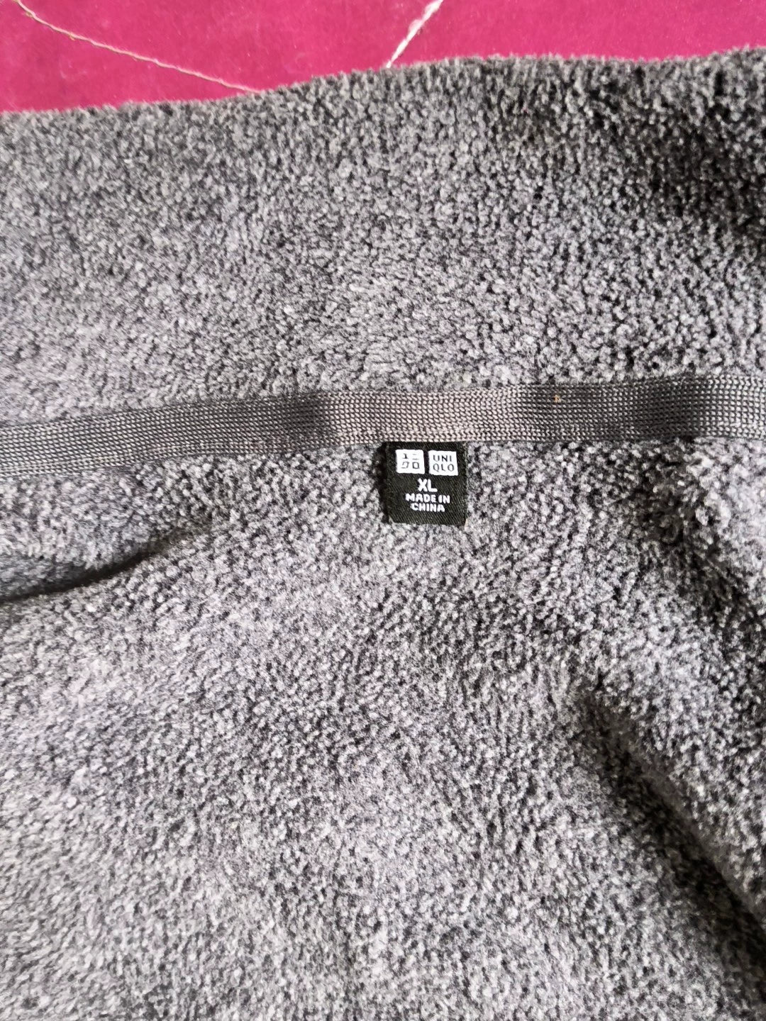 Uniqlo XL label on grey fleece jacket